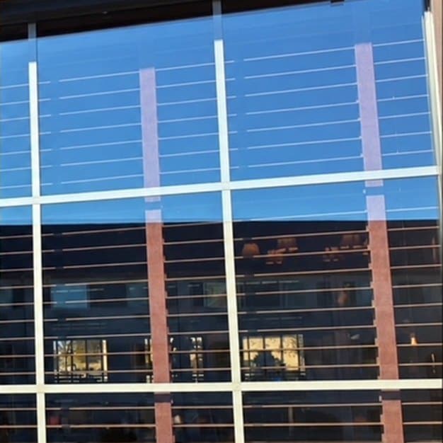 Storefront window with hard water haze before and after window cleaning by Ascension Exterior Services