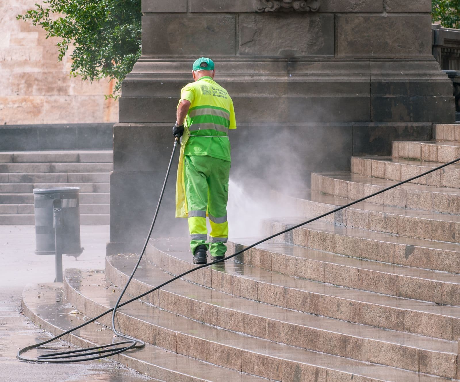 A surface being pressure washed, with the cleaned section clearly separated from the dirty section