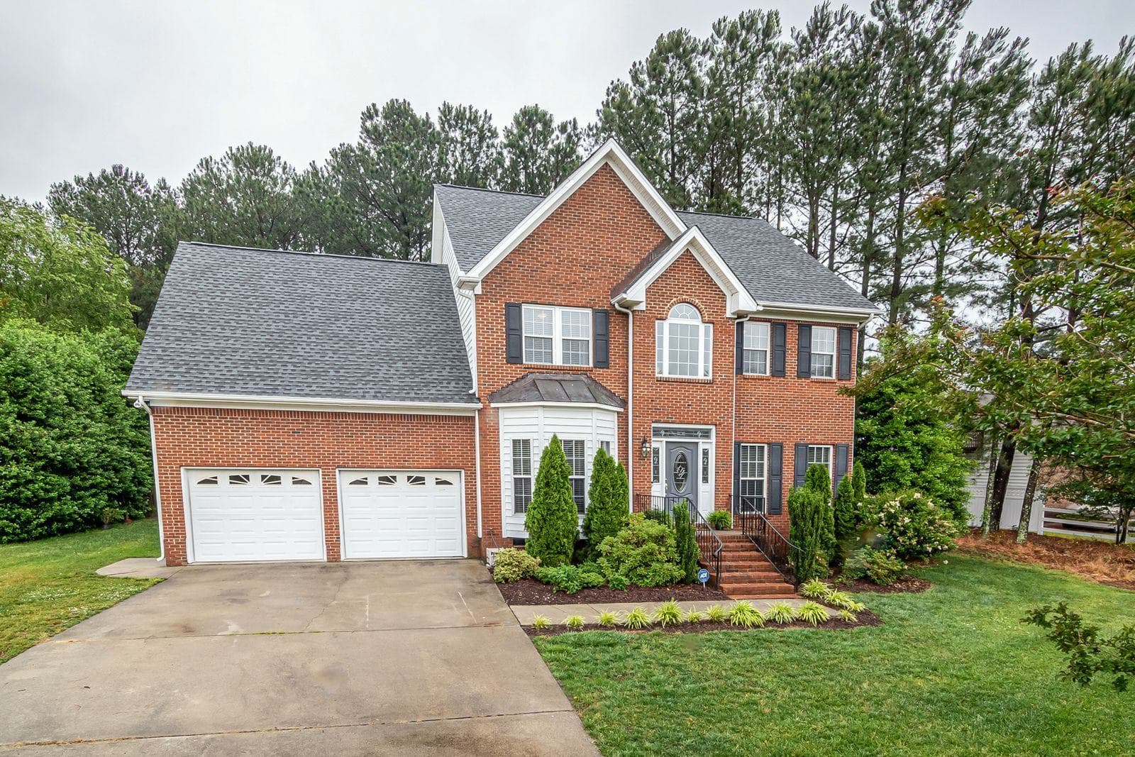 A brick and siding home with a clean exterior, the result a soft wash is aiming for