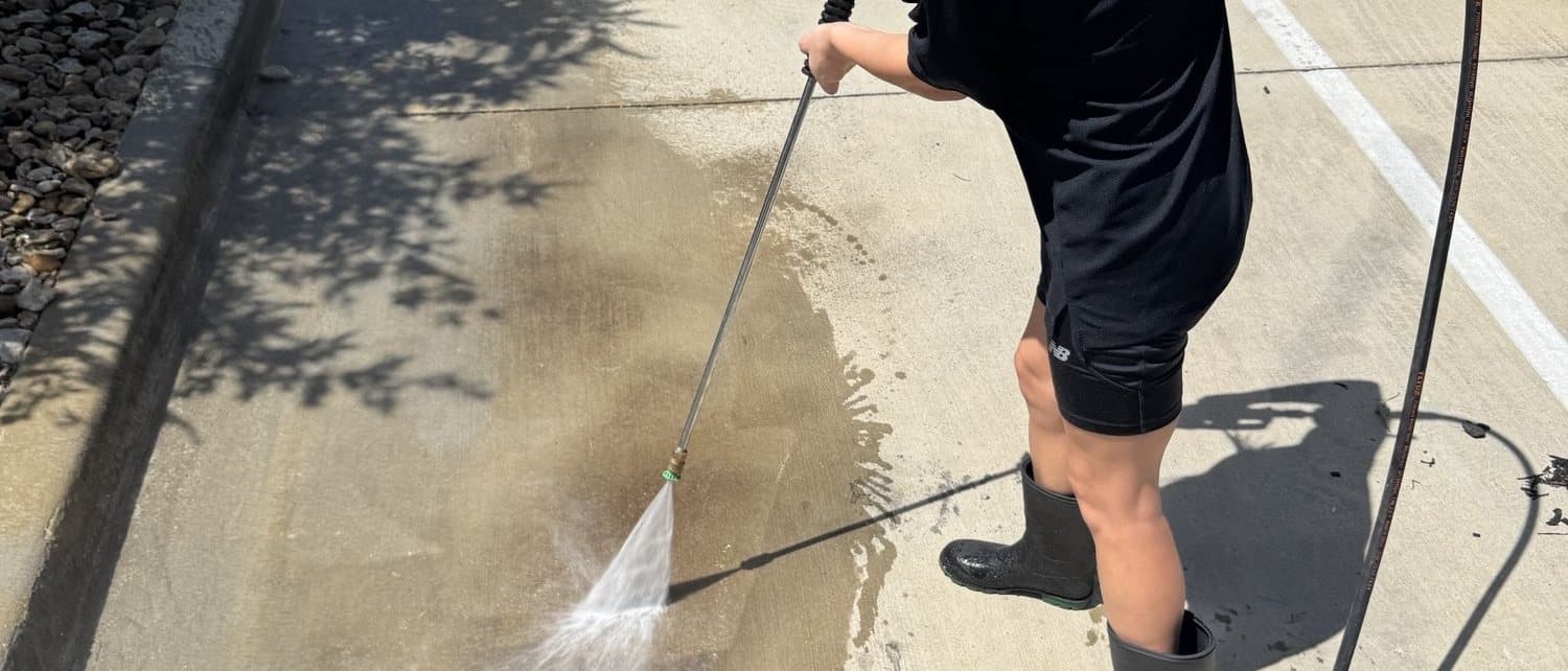 Brooke Wakeland of Ascension Exterior Services lifting an oil stain from a parking space