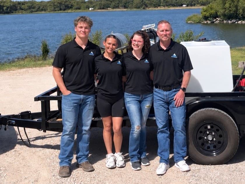 The Wakeland family, owners of Ascension Exterior Services, with the equipment trailer